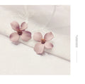 Alloy flower stud earrings with electroplated finish in white and pink colour options