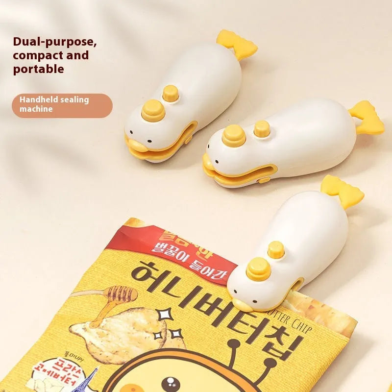 Small yellow rechargeable sealing machine with animal jacquard pattern and charging cable.