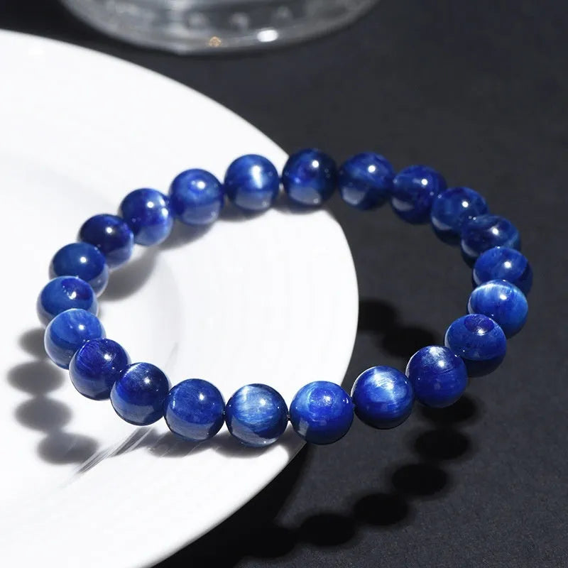 Natural blue crystal ball bracelet with geometric shape and Ruyi design on a white background.