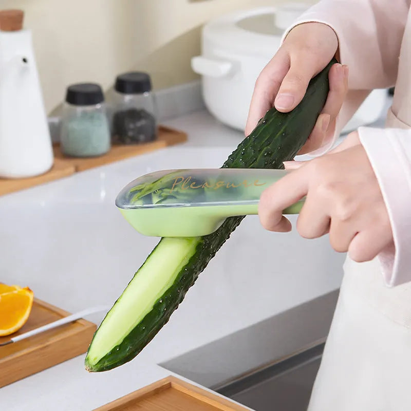 Green kitchen peeler with a stainless steel blade stored inside its transparent plastic tube.