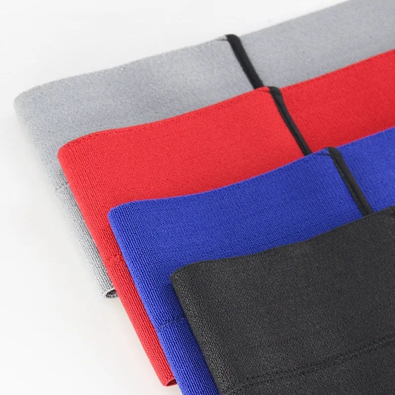 Elastic elbow support bandage in black colour, wrapped around an adult arm.