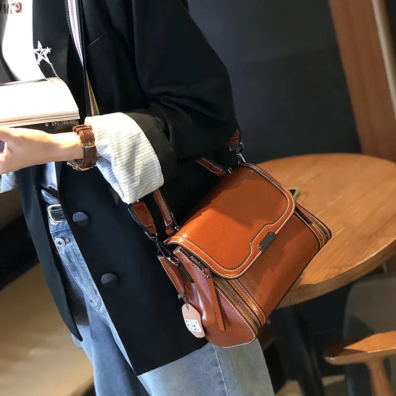 Genuine leather women's vintage messenger bag with multiple internal compartments in caramel colour