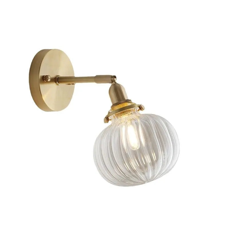 Creative pumpkin-shaped wall lamp with water ripple textured glass shade in blue, mounted on a white wall.