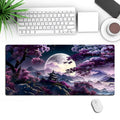 Large black gaming desk mat with pattern, shown on a desk with keyboard and mouse.
