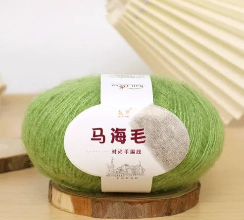 Ball of mohair yarn for DIY scarf knitting in one of 34 colours, including white, pink, blue, and green.