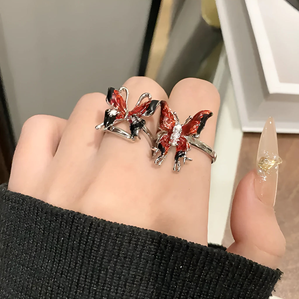 Creative butterfly design women's ring in copper with oil drip finish, showing an open loop style.