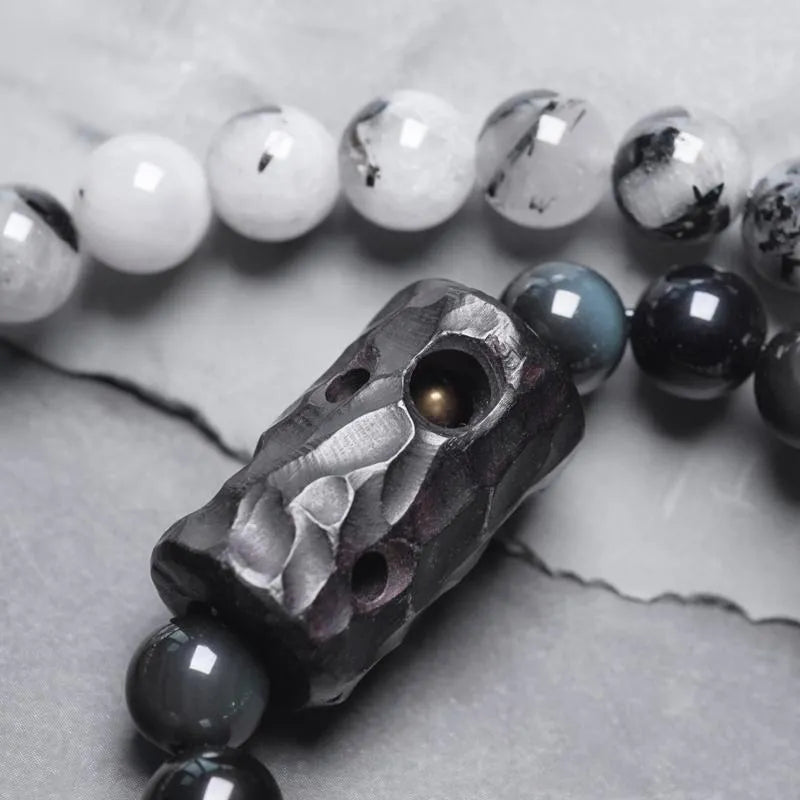 Men's ethnic black hair bracelet with white crystal tassel showing bending and lacing details