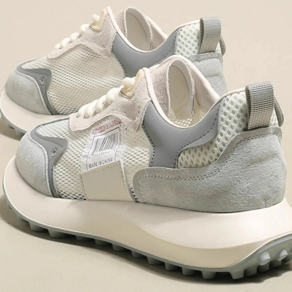 Women's grey and pink retro sneaker with low top design and round toe