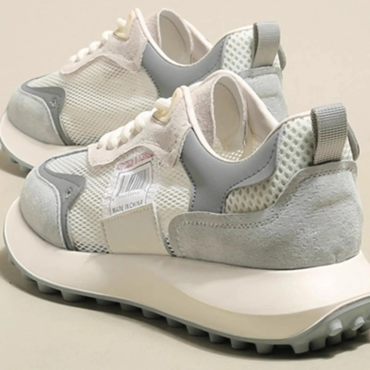 Women's grey and pink retro sneaker with low top design and round toe