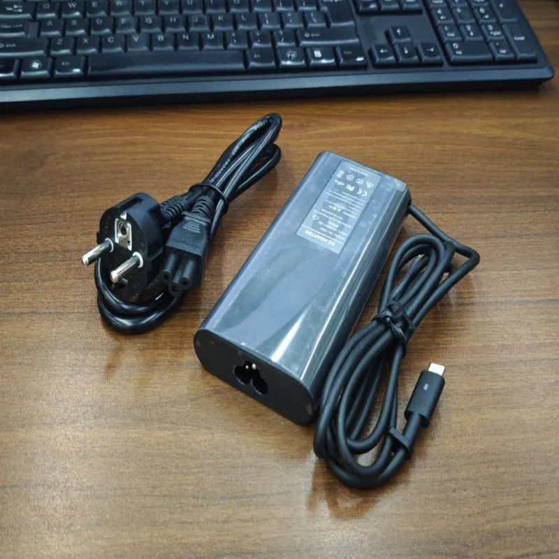 Black 65W laptop Type-C power adapter with multiple international plug cords