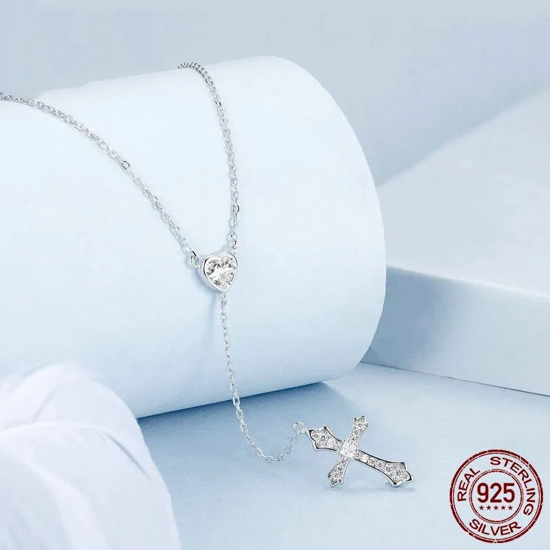 Women's silver love cross necklace with V-neck pendant on O-ring chain.