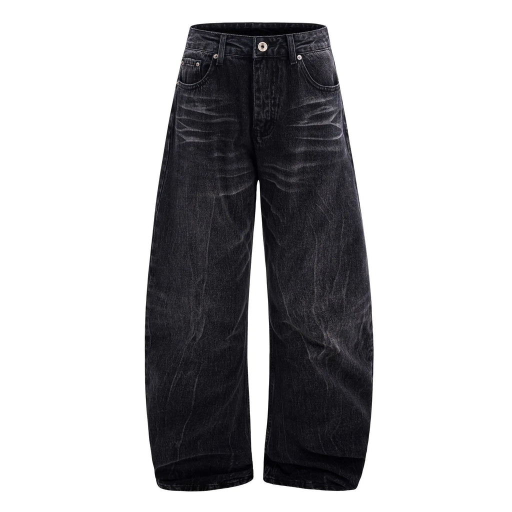 Men's black American washed straight leg jeans with old lightning crack detailing on a plain background