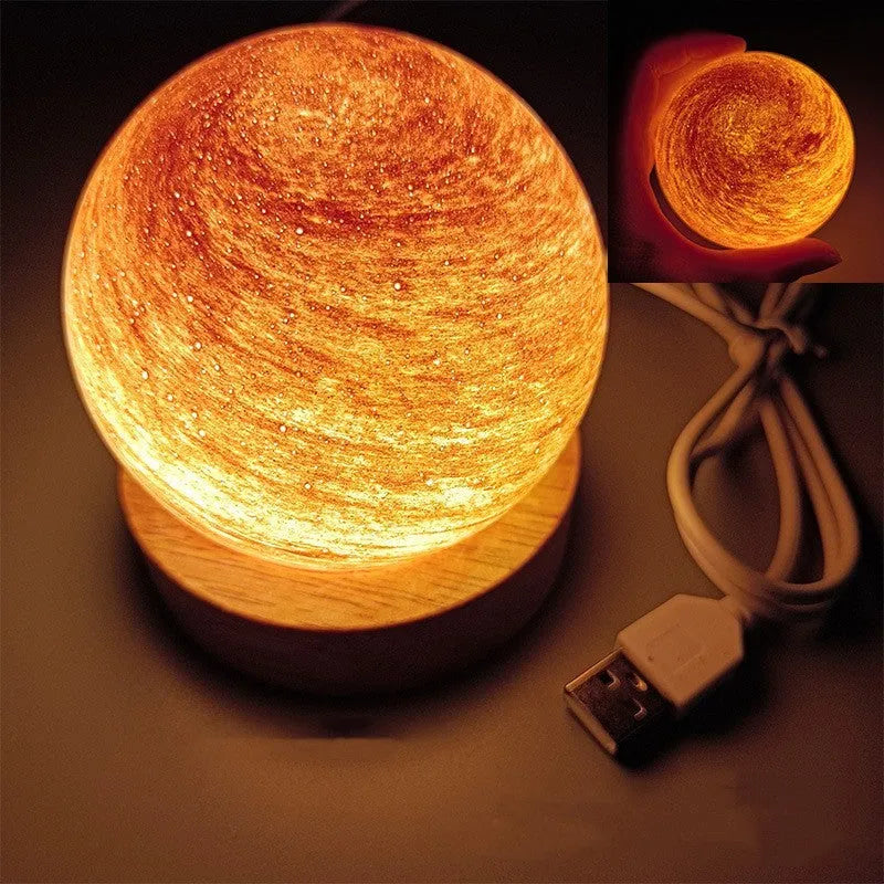 Modern planet-shaped USB night light with dimming on a desk.