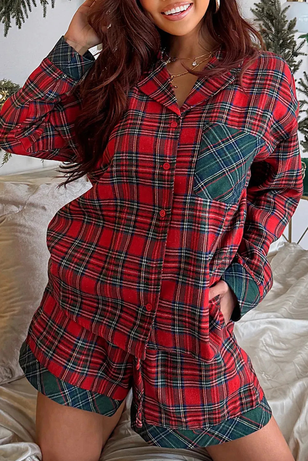 Red plaid Christmas pyjama set with contrast patches on shirt and shorts, laid flat.
