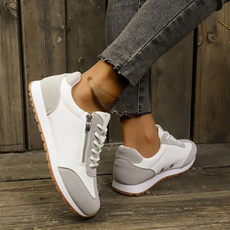 Women's flat-heeled shoes in grey, white and Champagne colours with artificial PU upper and rubber sole.
