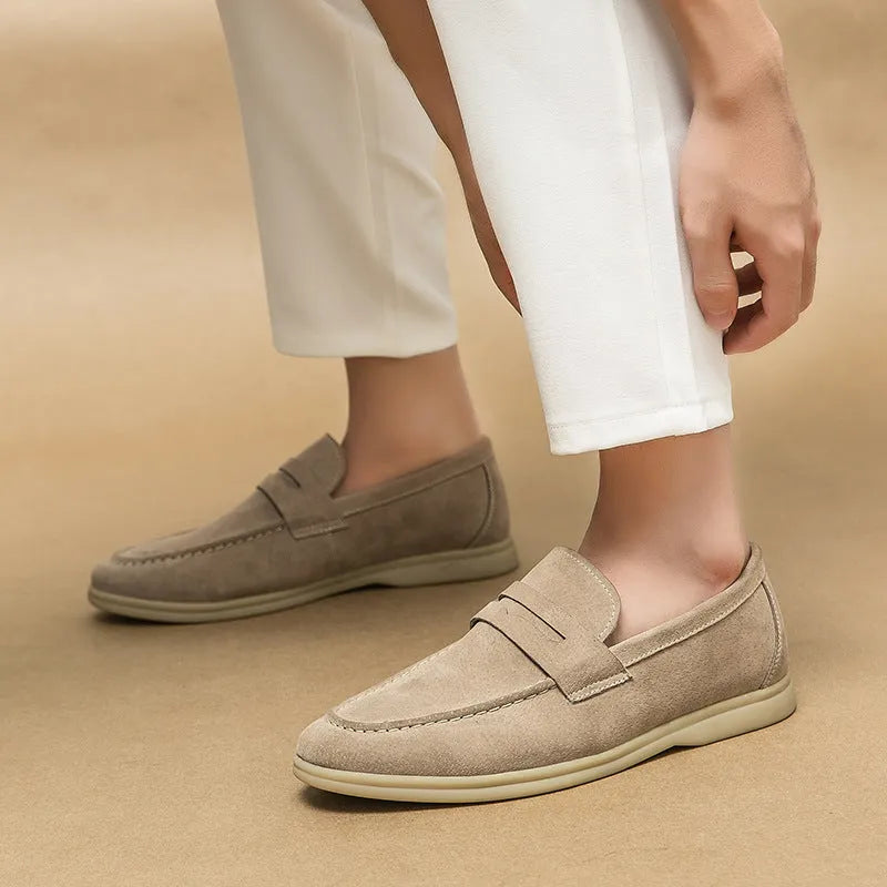 Men's black leather slip-on casual shoes with a round toe and rubber sole on a white background.