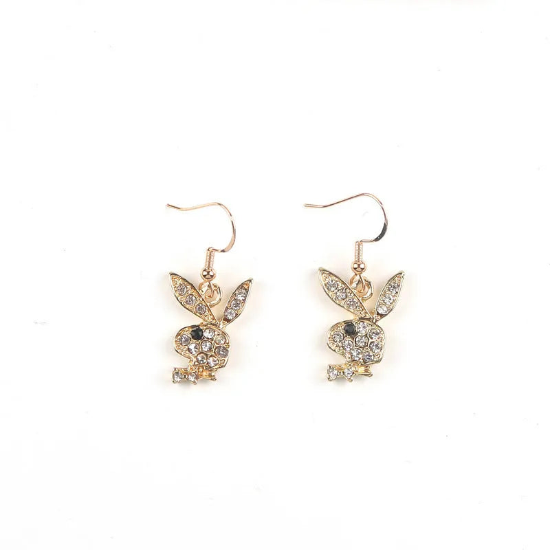 Close-up of rabbit-shaped stud earrings with sparkling cubic zirconia stones in gold, pink, and silver finishes.