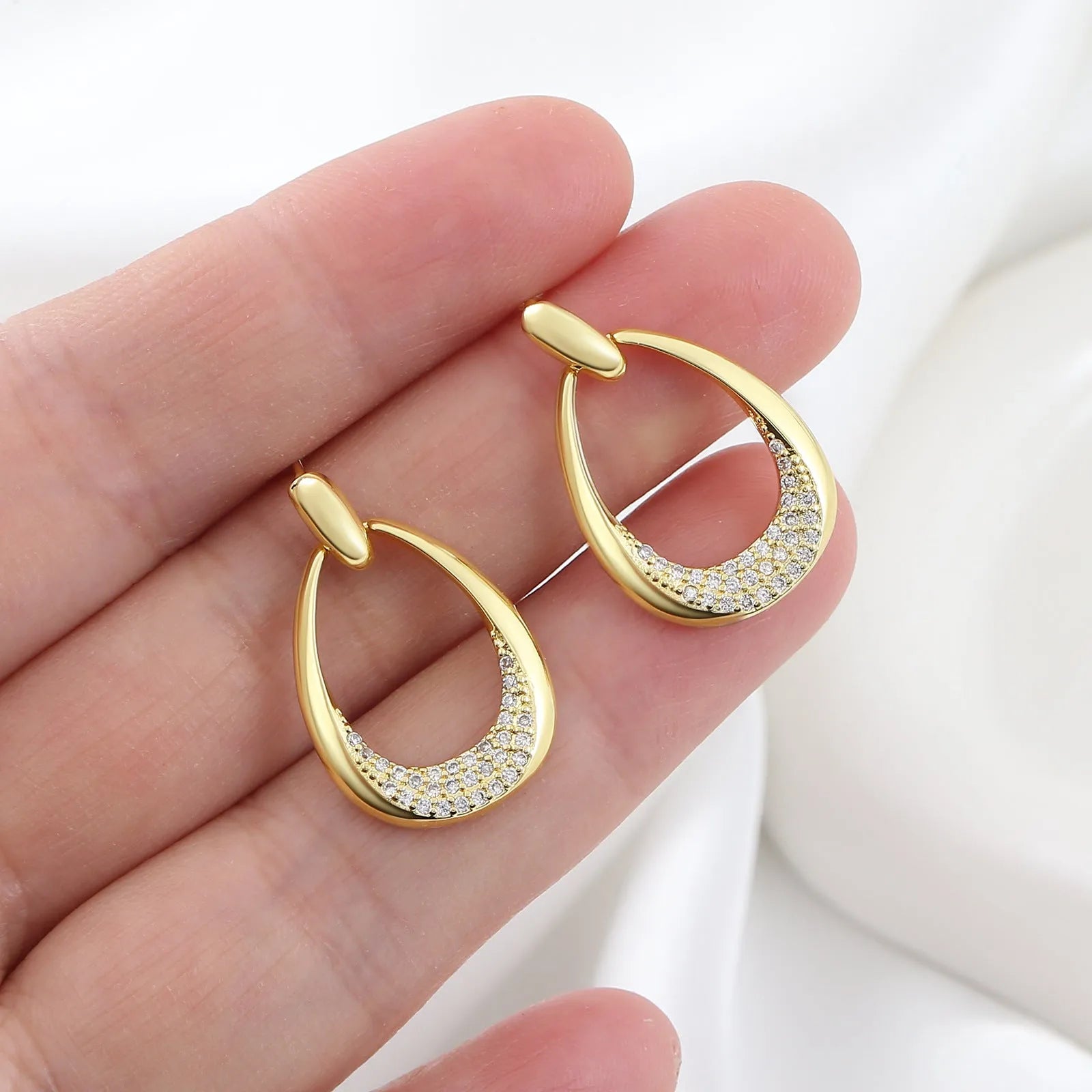 Yellow gold geometric drop earrings for women on a plain background, showing their 2.6 cm length.