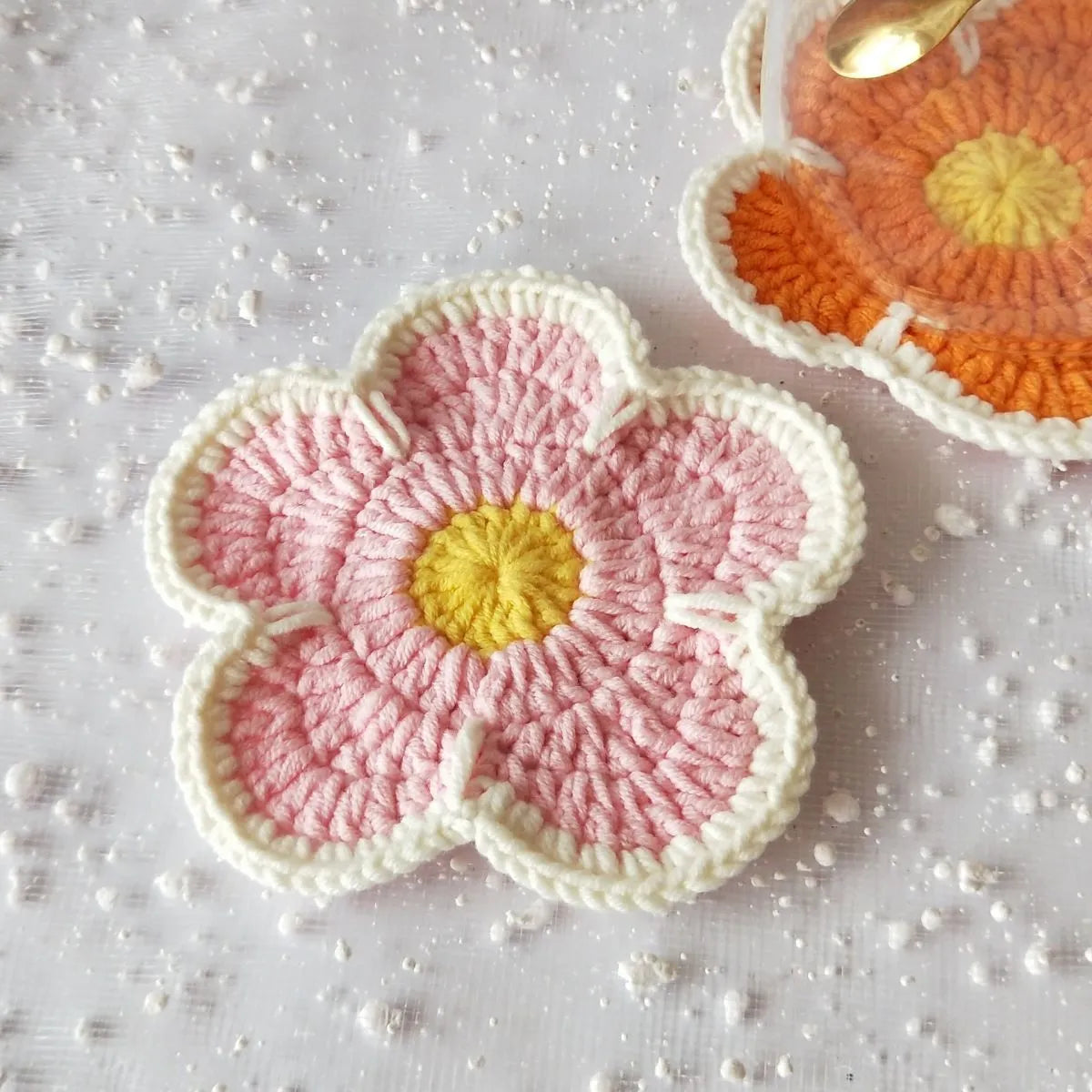 Colourful handmade cotton thread woven flower placemats on dining table