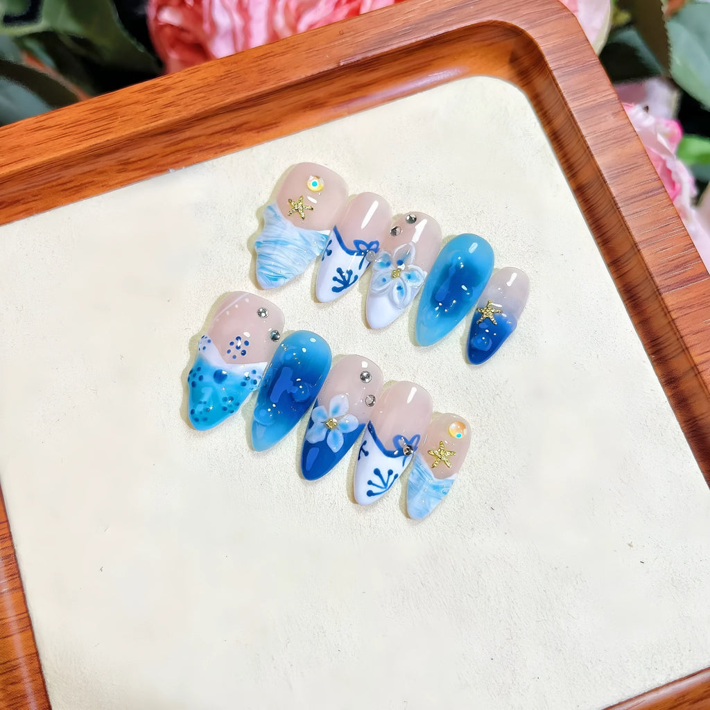Set of hand-painted blue plastic fake nails with carved Summer Ice design in four sizes XS S M L