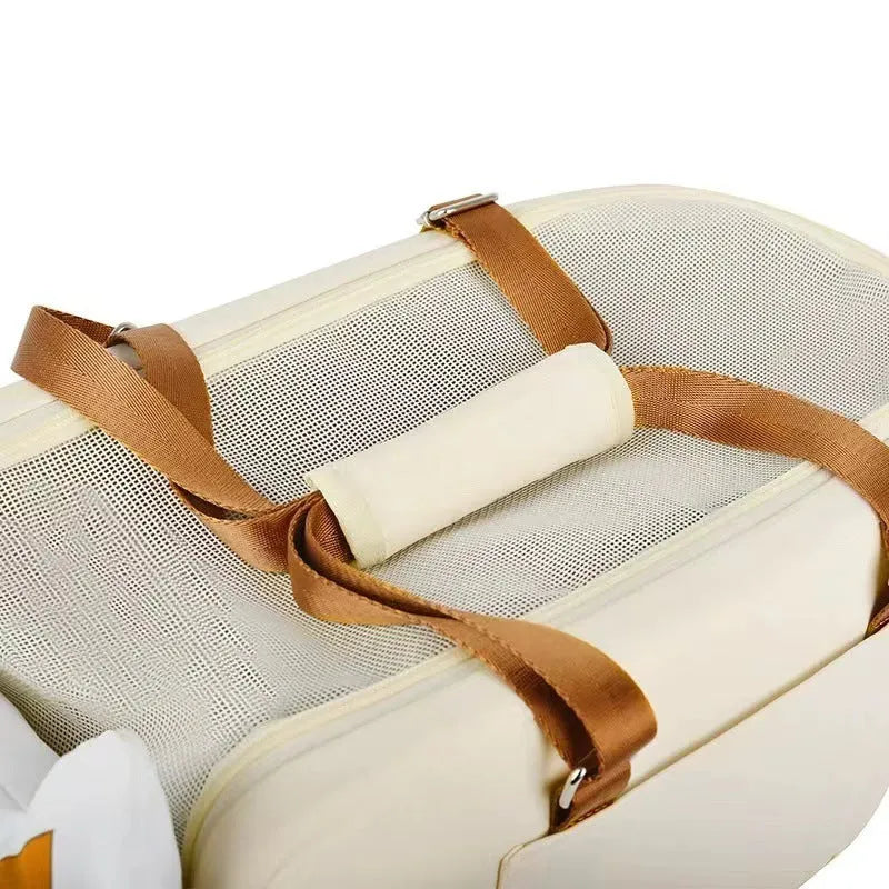 Beige hard-shell cat carrier with one shoulder strap showing EPE padding construction