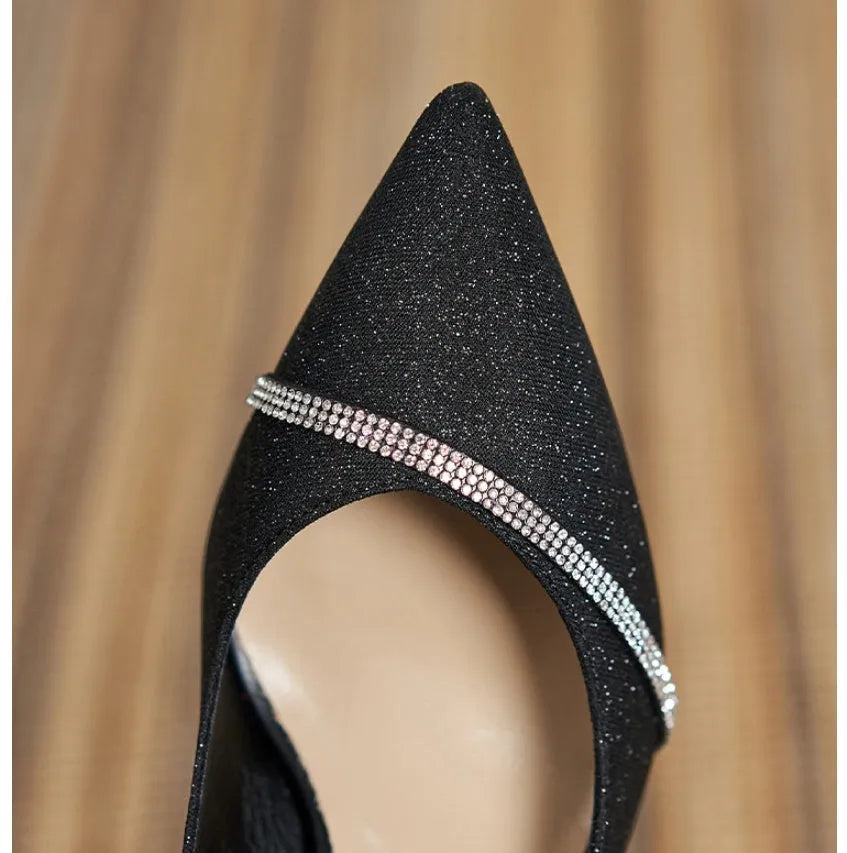 Black sequined women's high heel shoes with a 7cm thin stiletto heel on a neutral background.