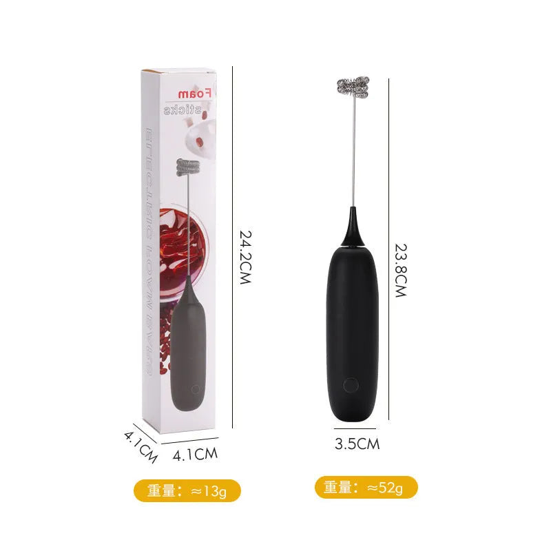 A handheld electric milk frother and blender in black and white colours on a kitchen counter.