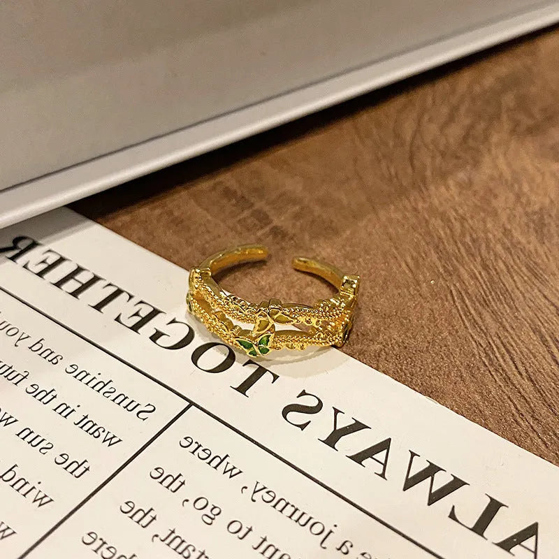 Creative butterfly design women's ring in copper with oil drip finish, showing an open loop style.
