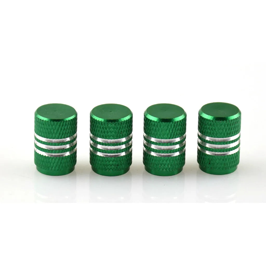 Assortment of aluminium alloy car tyre valve caps in ten different colours on a grey background.
