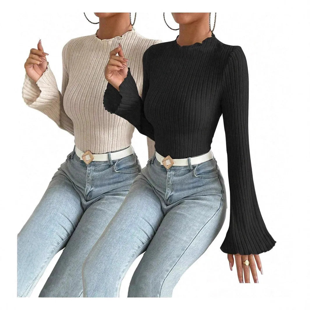 Long sleeve black top with lantern sleeves and sunken stripe texture, laid flat.