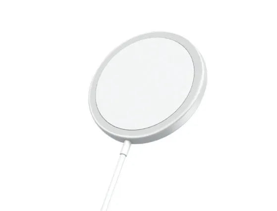Silver metal Magsafe-compatible magnetic wireless charger for iPhone on a wooden desk
