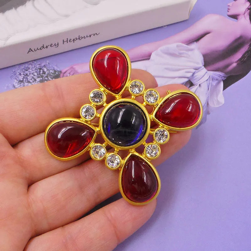 Close-up of a vintage medieval baroque cross brooch in zinc alloy with crystal accents, showing intricate detail.