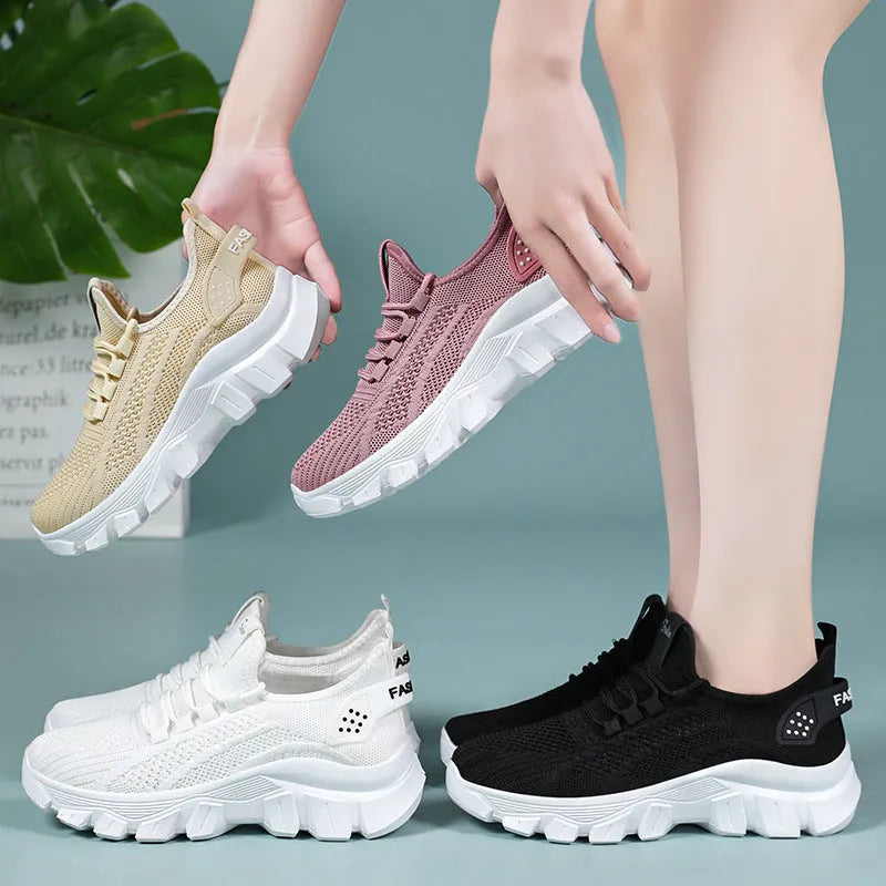 Women's white Flyknit sneakers with thick PVC sole and lace-up front on a neutral background.