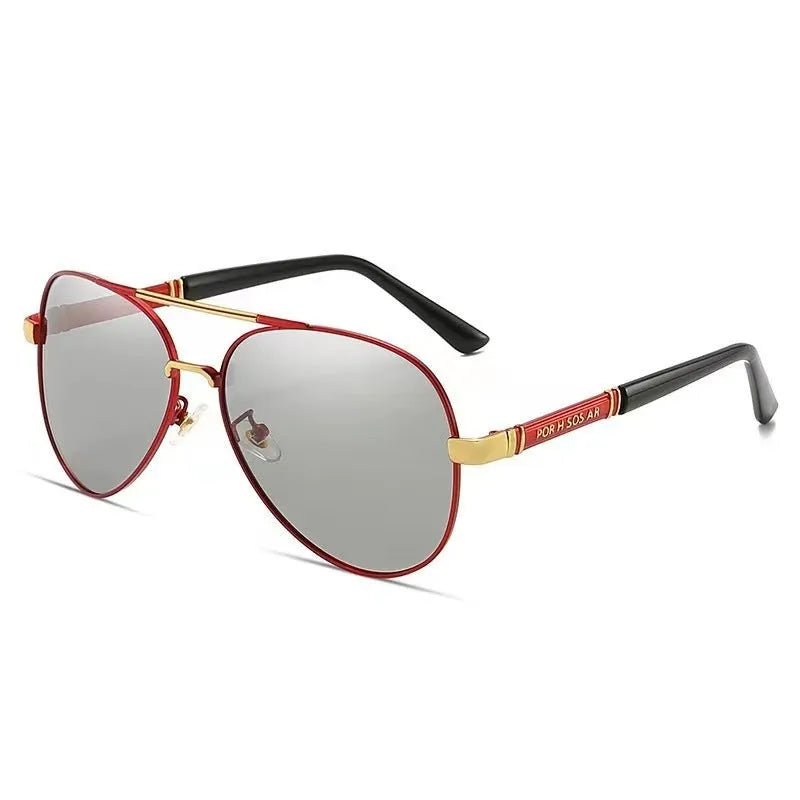 Gold metal frame polarised sunglasses with grey lenses on a table, showing dragon and phoenix temple detail.