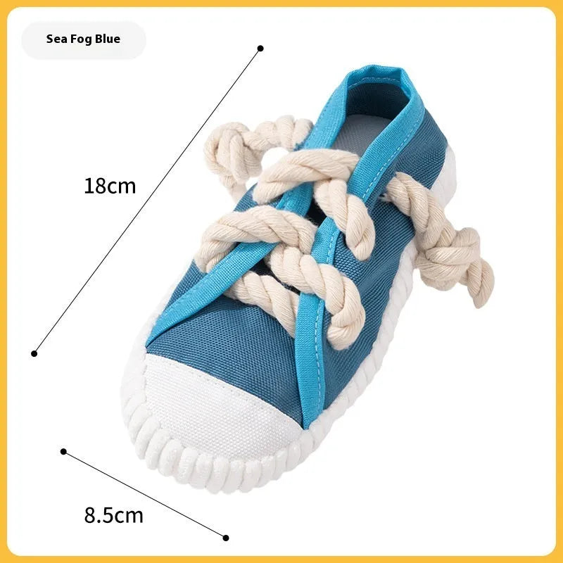 Yellow plastic dog slippers chew toy with a squeaker on a white background.