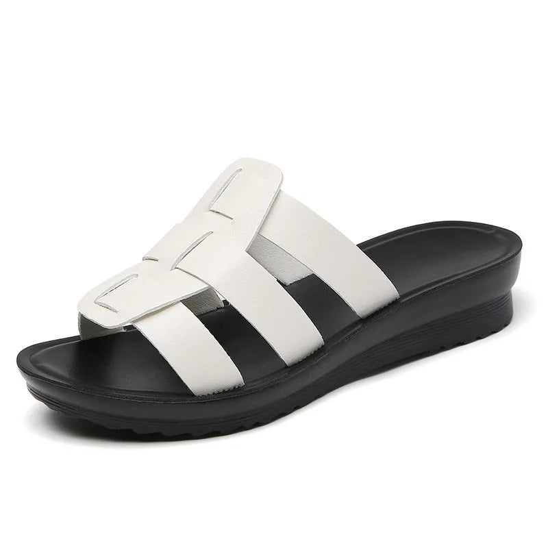 Beige waxed leather women's flat bottom slippers on a white background, showing the soft sole and viscose lining.