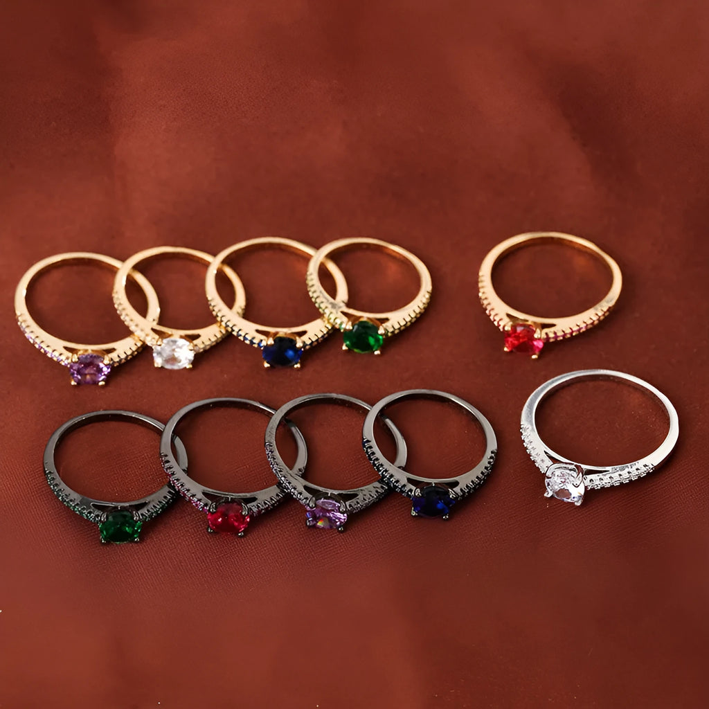 Geometric hexagonal copper ring with a zircon stone, shown in a gold rose red electroplated finish on a size 7 finger.