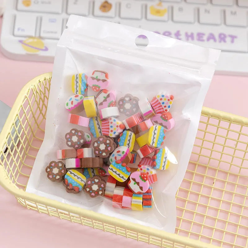 Sealed plastic bag containing 50 small cartoon-themed erasers in shapes like fruits, animals, and Christmas symbols.