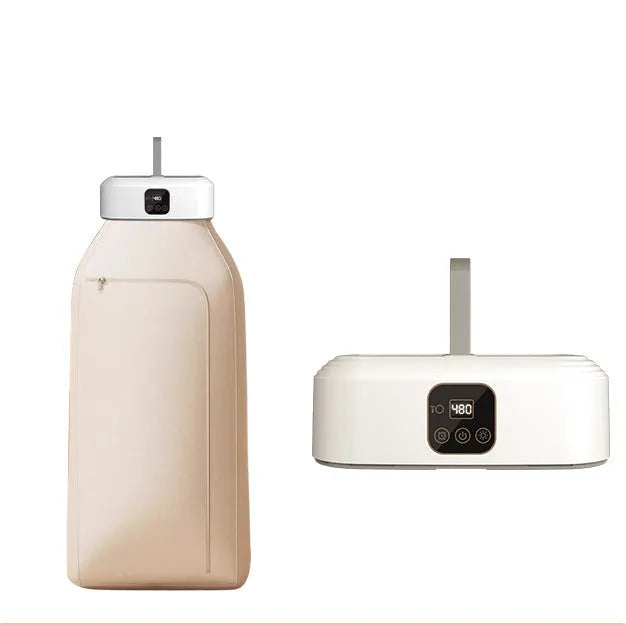 White cylindrical portable laundry drier dryer with remote control on a countertop.