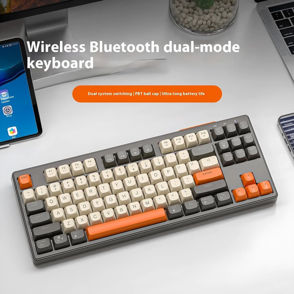 Compact wireless Bluetooth keyboard in blueberry colour with USB receiver and cable on a desk.
