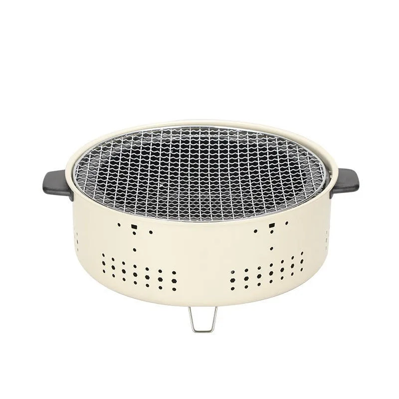 Compact round indoor charcoal stove with removable metal grill rack, for smokeless tabletop cooking.