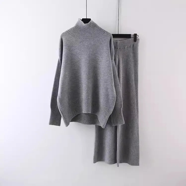 Women's milky white acrylic two-piece set with long sleeve top and wide-leg trousers on a hanger.