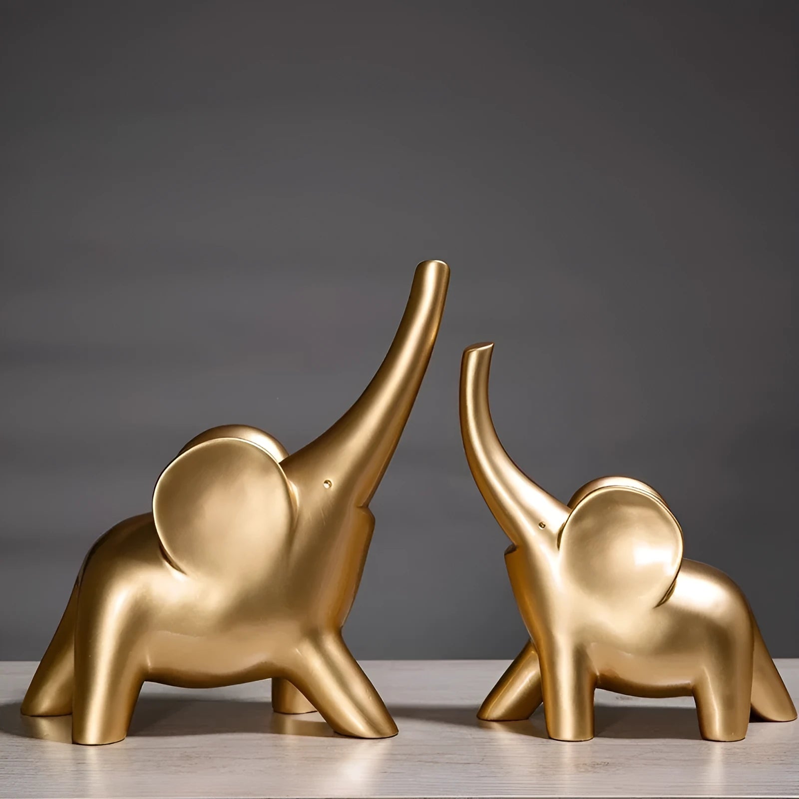 Modern minimalist elephant figurine ornament in rose gold or white resin on a plain background.