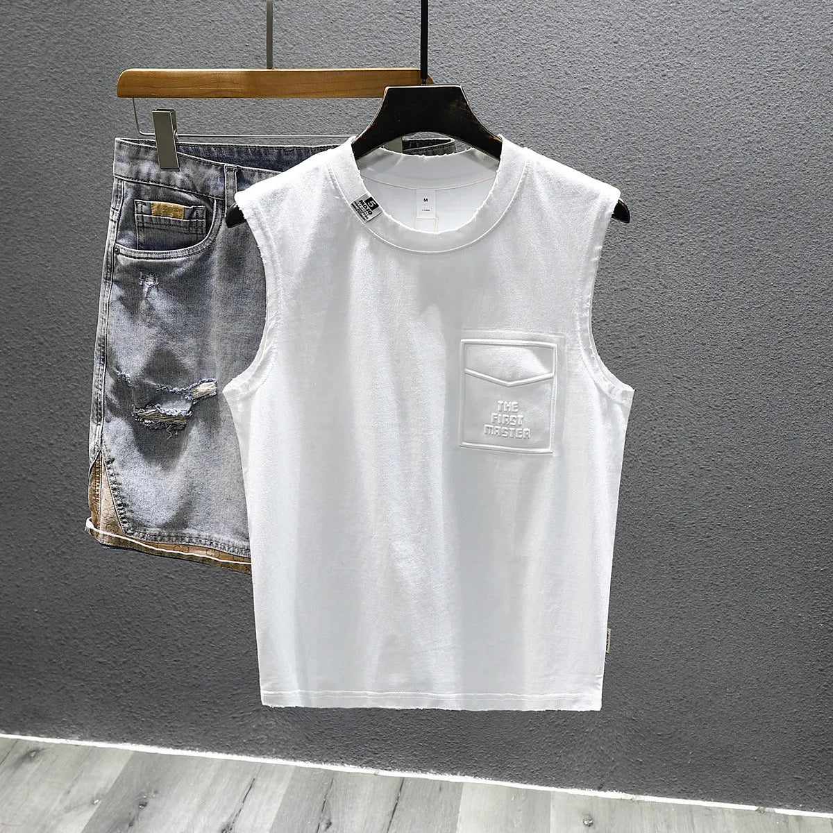 A solid colour loose-fitting cotton sleeveless T-shirt with a straight hem, shown in white.