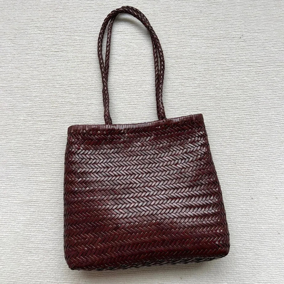 Brown handmade woven leather tote bag with a three-dimensional pocket.