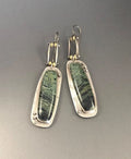 Geometric drop earrings with a white and grey marble pattern on a silver-toned alloy setting.