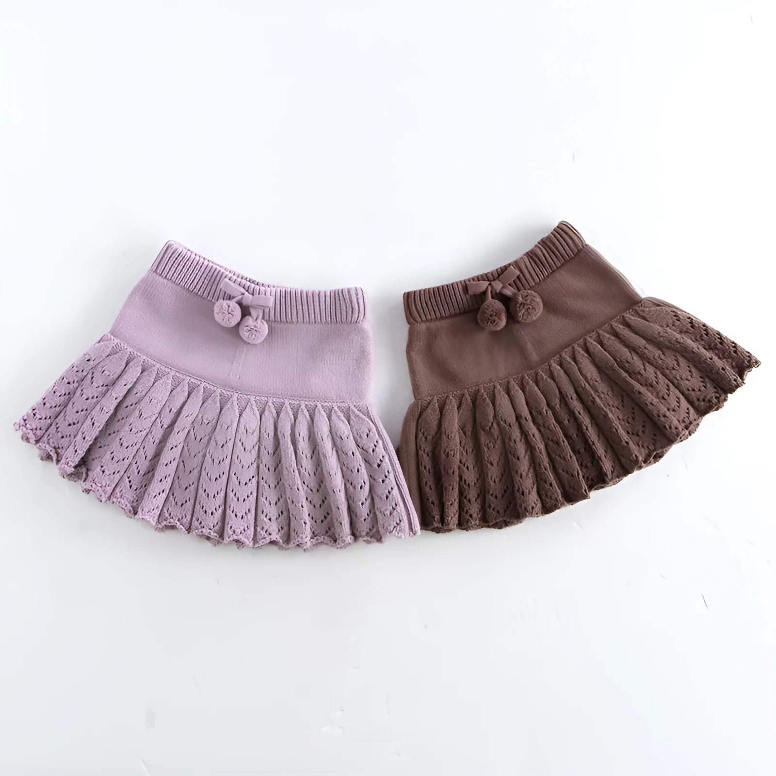 Girls hollow retro pleated pantskirt in light gray purple cotton, front view, on child of about 90cm height