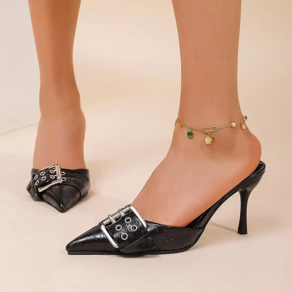 Black women's high heels with pointed toe and decorative buckle ankle strap