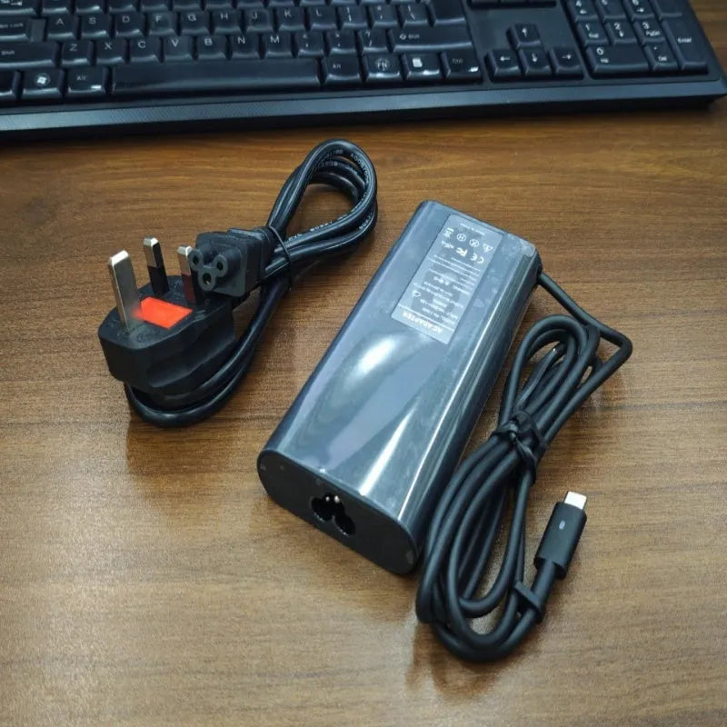 Black 65W laptop Type-C power adapter with multiple international plug cords