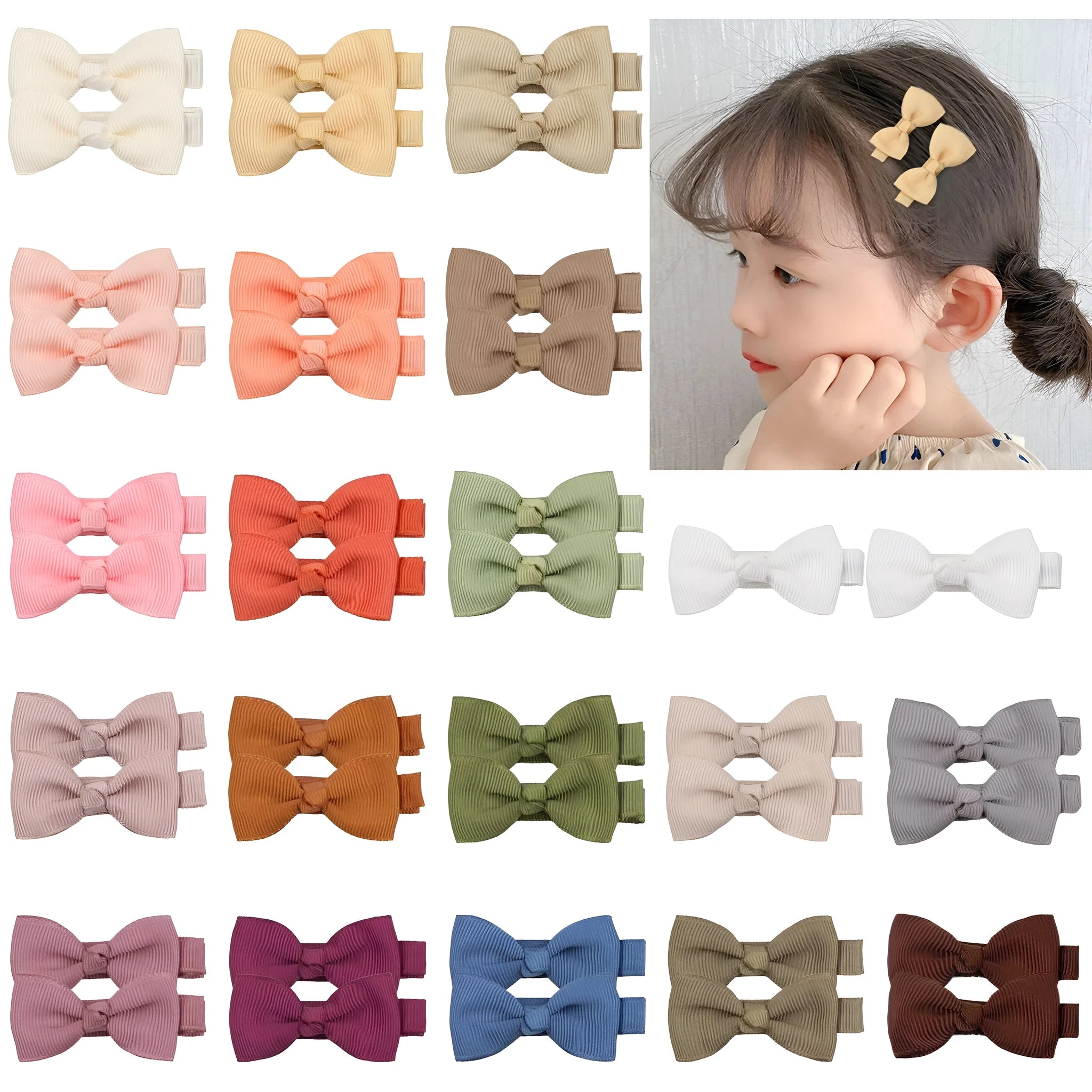 Assortment of pastel-coloured baby hair clips including barrettes and bows on a white background.